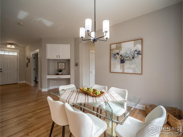 2946 Shoshone Trl, Lafayette, CO 80026 - dining space featuring a chandelier and light wood-style floors