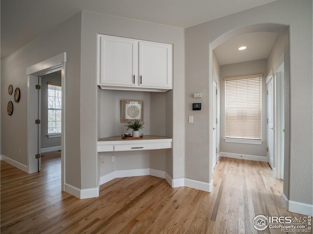 2946 Shoshone Trl, Lafayette, CO 80026 - corridor with arched walkways and light wood-type flooring