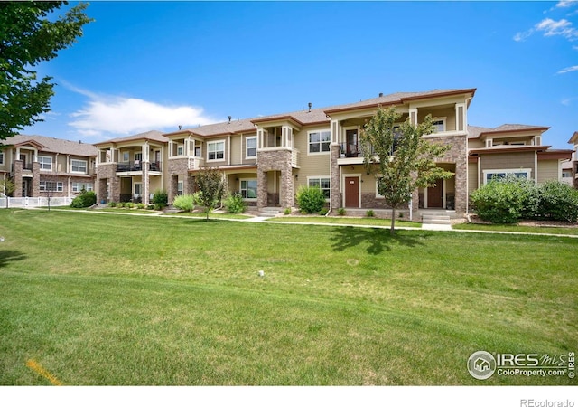 4902 Brookfield Dr # G, Fort Collins, CO 80528 - view of front of home with a balcony, a front yard, stone siding, and a residential view