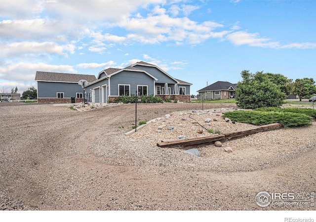 20199 Leola Way, Eaton, CO 80615 - view of front of home with an attached garage, dirt driveway, and brick siding