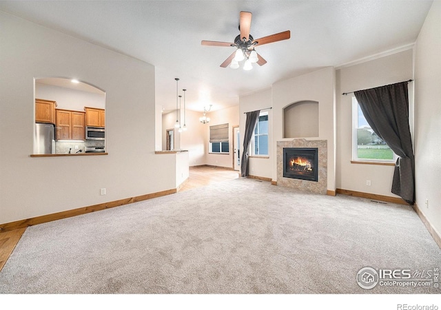 20199 Leola Way, Eaton, CO 80615 - unfurnished living room with a ceiling fan, carpet flooring, and plenty of natural light