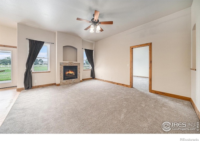 20199 Leola Way, Eaton, CO 80615 - unfurnished living room with carpet flooring, ceiling fan, and a high end fireplace