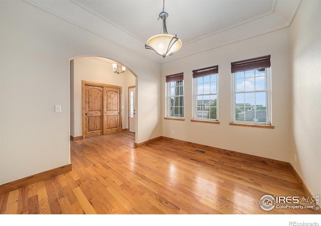 20199 Leola Way, Eaton, CO 80615 - spare room with arched walkways, light wood-style flooring, and crown molding
