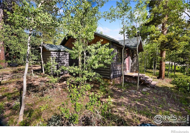 11614 Peak To Peak Hwy, Allenspark, CO 80510 - view of property exterior featuring a shed and faux log siding