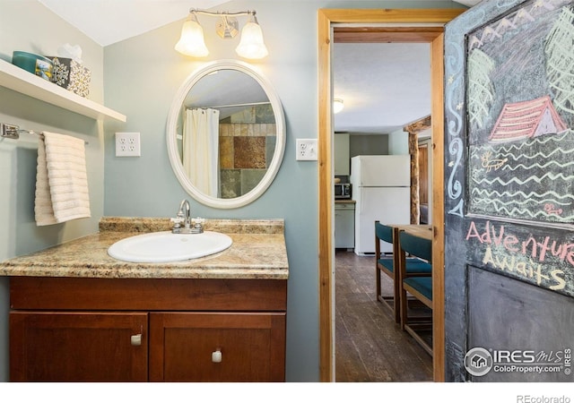 11614 Peak To Peak Hwy, Allenspark, CO 80510 - full bath featuring wood finished floors, vanity, and a shower with curtain