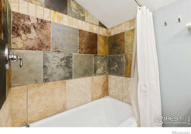 11614 Peak To Peak Hwy, Allenspark, CO 80510 - full bathroom featuring shower / tub combo with curtain and lofted ceiling