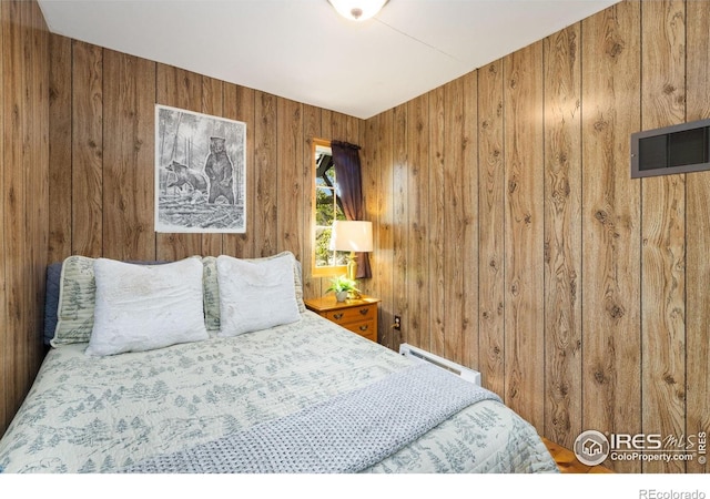 11614 Peak To Peak Hwy, Allenspark, CO 80510 - bedroom featuring wooden walls and a baseboard heating unit