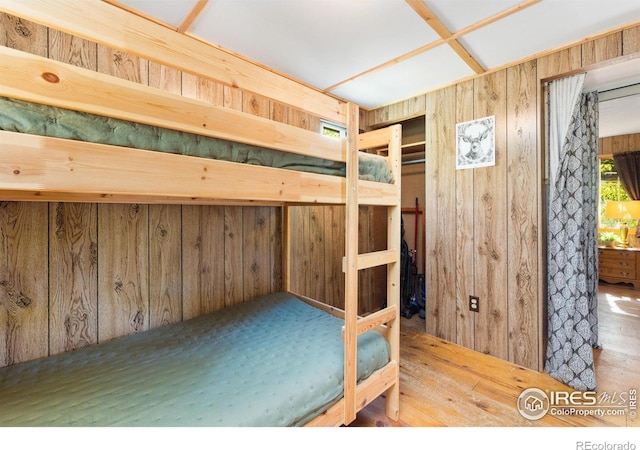 11614 Peak To Peak Hwy, Allenspark, CO 80510 - unfurnished bedroom with wooden walls and wood finished floors