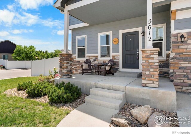 5612 Osbourne Dr, Windsor, CO 80550 - property entrance with a porch and stone siding