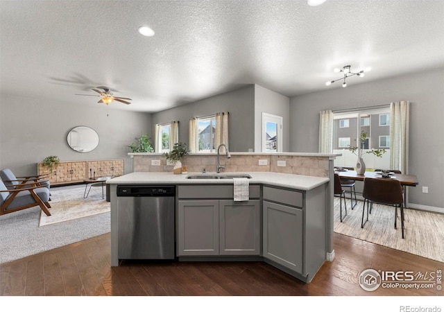5612 Osbourne Dr, Windsor, CO 80550 - kitchen with stainless steel dishwasher, gray cabinets, light countertops, dark wood finished floors, and a textured ceiling