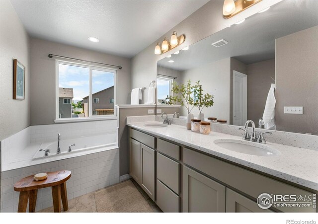 5612 Osbourne Dr, Windsor, CO 80550 - full bath with double vanity, a garden tub, and tile patterned floors