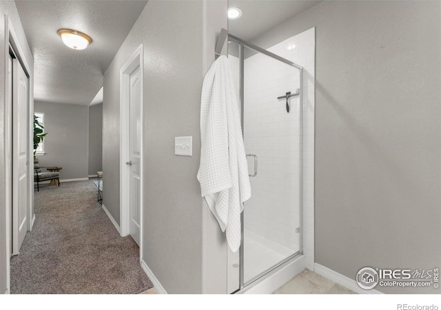 5612 Osbourne Dr, Windsor, CO 80550 - bathroom featuring a stall shower and a textured ceiling