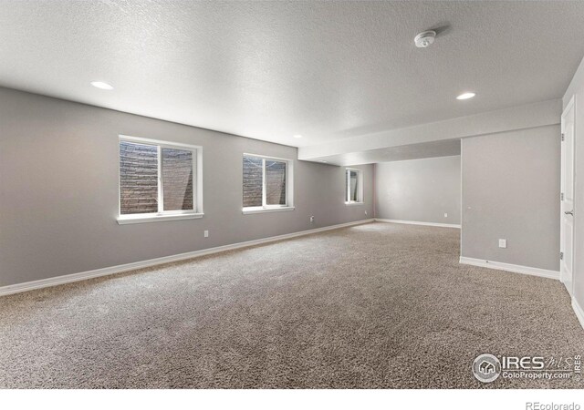 5612 Osbourne Dr, Windsor, CO 80550 - carpeted empty room featuring a smoke detector, a textured ceiling, and recessed lighting