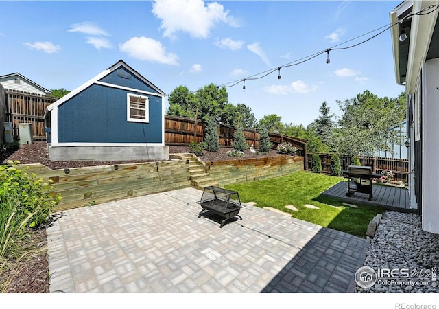 3593 S Gibralter Cir, Aurora, CO 80013 - fenced backyard with a fire pit, a patio, and a wooden deck