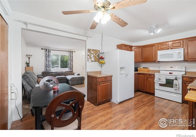 3920 Windom St, Fort Collins, CO 80526 - kitchen featuring white appliances, brown cabinetry, light wood-style flooring, and ceiling fan