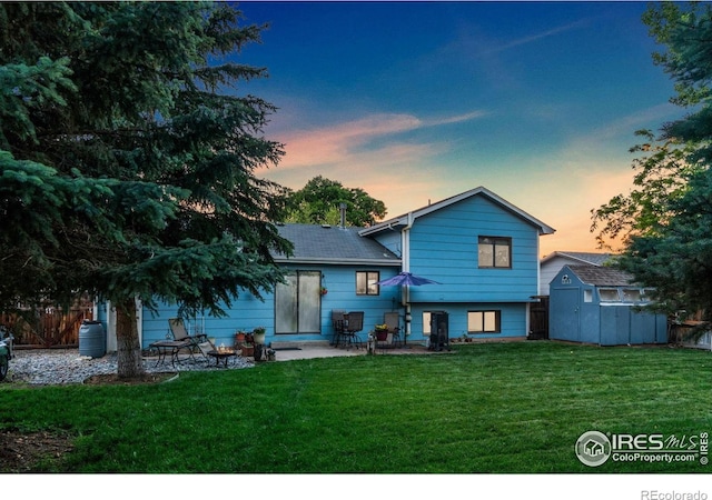3920 Windom St, Fort Collins, CO 80526 - back of property with a storage shed, a yard, a patio area, and a shingled roof