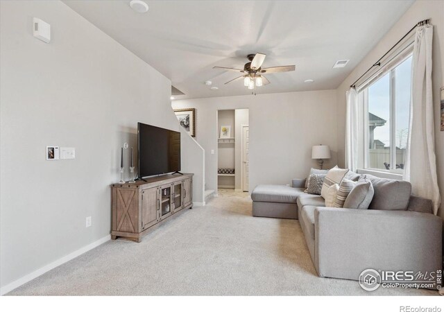 362 Bozeman Trl, Ault, CO 80610 - carpeted living area featuring a ceiling fan and stairs