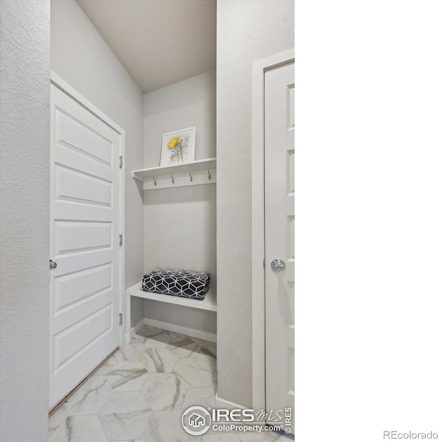 362 Bozeman Trl, Ault, CO 80610 - mudroom featuring marble look tiles and baseboards