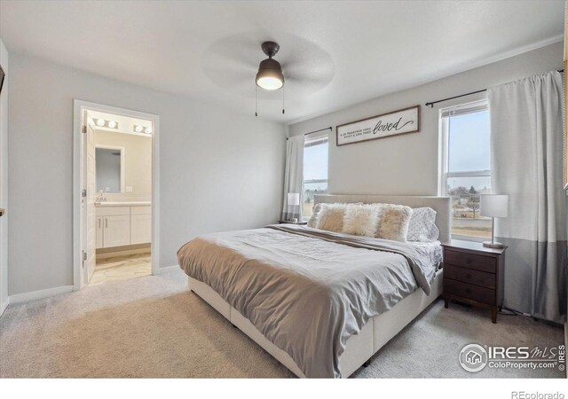 362 Bozeman Trl, Ault, CO 80610 - bedroom with light carpet, connected bathroom, and a ceiling fan