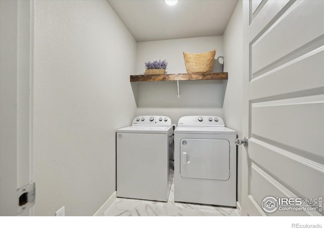 362 Bozeman Trl, Ault, CO 80610 - laundry room featuring separate washer and dryer and light marble finish flooring