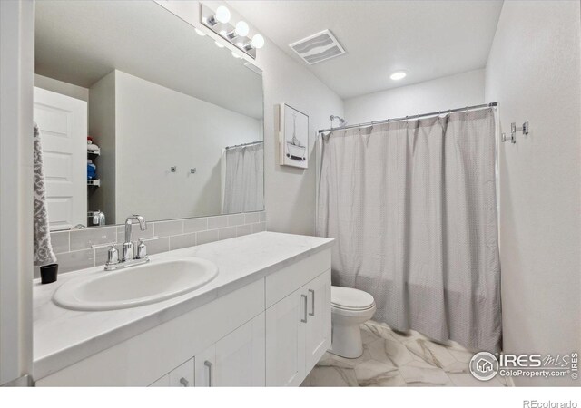 362 Bozeman Trl, Ault, CO 80610 - bathroom featuring marble look tiles, vanity, and backsplash