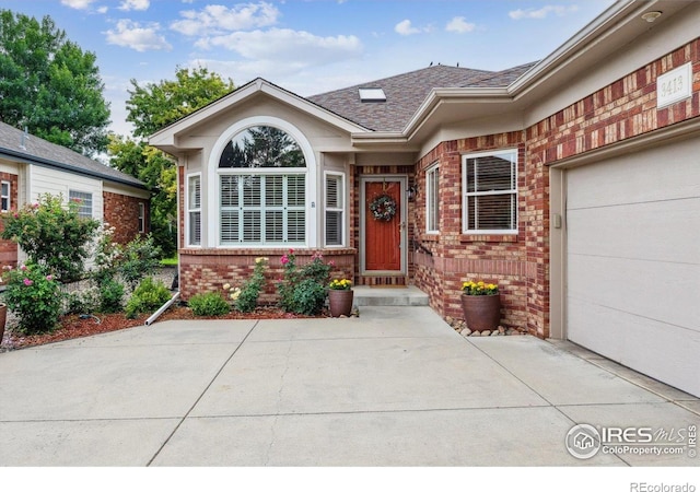 3413 Boxelder Dr, Longmont, CO 80503 - entrance to property with brick siding, roof with shingles, and an attached garage