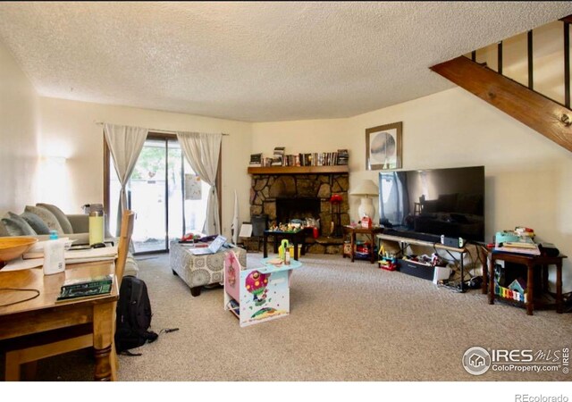 1325 Birch St Unit 12, Fort Collins, CO 80521 - living area featuring carpet flooring, a textured ceiling, and a fireplace