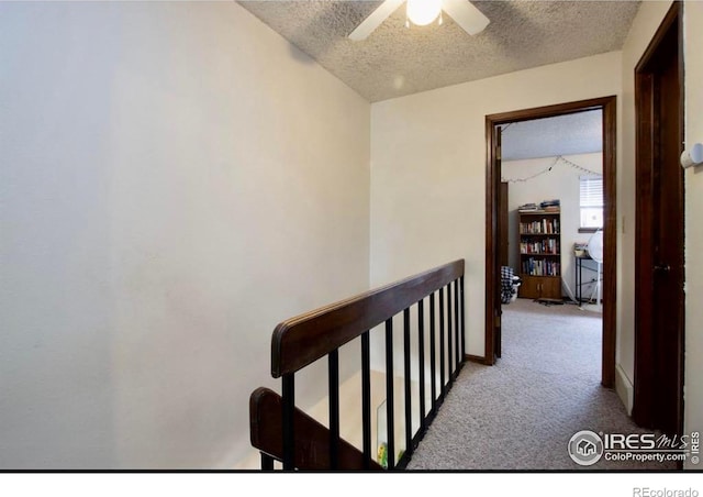 1325 Birch St Unit 12, Fort Collins, CO 80521 - hallway featuring an upstairs landing, a textured ceiling, and carpet