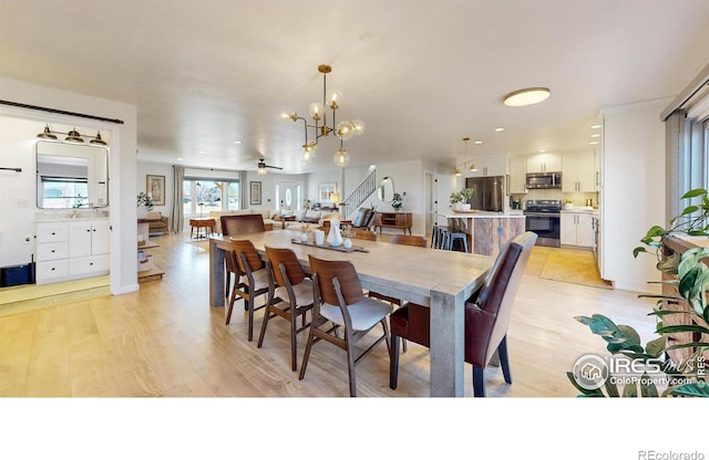 1403 Crestridge Dr, Loveland, CO 80537 - dining room with light wood finished floors, a chandelier, and recessed lighting