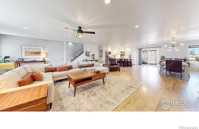 1403 Crestridge Dr, Loveland, CO 80537 - living room with a chandelier, stairway, light wood finished floors, and recessed lighting