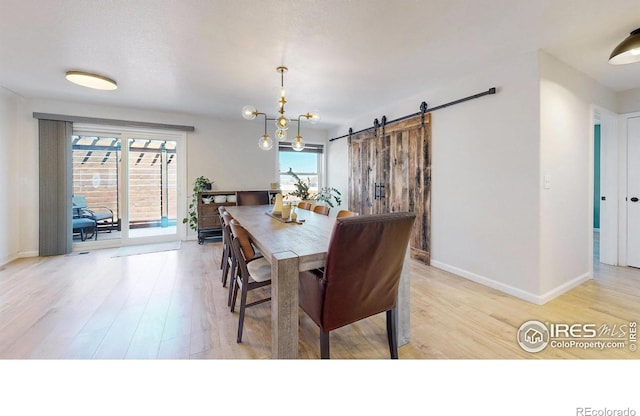 1403 Crestridge Dr, Loveland, CO 80537 - dining room with light wood-style flooring and a barn door