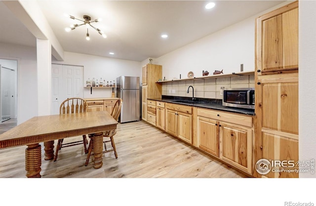 1403 Crestridge Dr, Loveland, CO 80537 - kitchen featuring appliances with stainless steel finishes, open shelves, backsplash, recessed lighting, and light wood finished floors