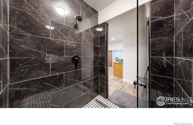 1403 Crestridge Dr, Loveland, CO 80537 - full bathroom with a tile shower and wood finished floors
