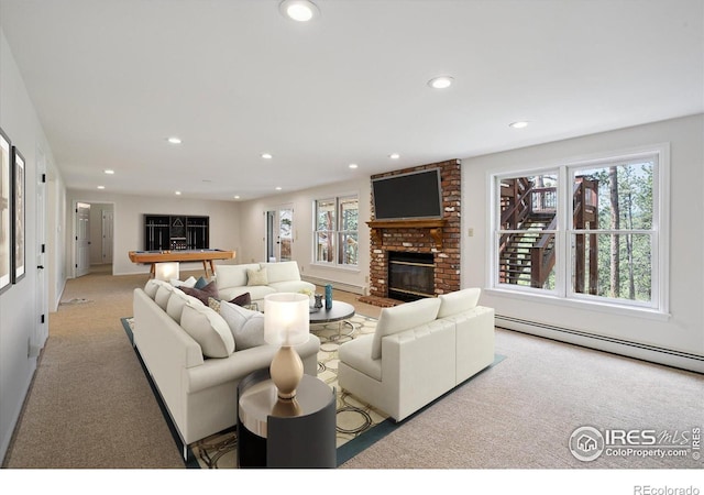 2023 Mammoth Ct, Evergreen, CO 80439 - living area with a baseboard radiator, healthy amount of natural light, a brick fireplace, recessed lighting, and carpet flooring