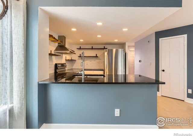 5918 Gunbarrel Ave Unit B, Boulder, CO 80301 - kitchen featuring extractor fan, appliances with stainless steel finishes, a peninsula, tasteful backsplash, and recessed lighting