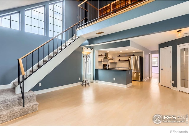 5918 Gunbarrel Ave Unit B, Boulder, CO 80301 - unfurnished living room with wood finished floors, stairway, and a high ceiling