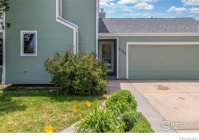 2707 W Stuart St, Fort Collins, CO 80526 - doorway to property featuring concrete driveway, a garage, a yard, and roof with shingles
