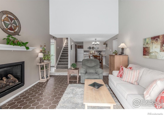 2707 W Stuart St, Fort Collins, CO 80526 - living area with a towering ceiling, stairs, a chandelier, and a glass covered fireplace