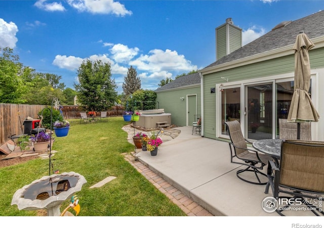 2707 W Stuart St, Fort Collins, CO 80526 - fenced backyard featuring a hot tub, a patio, and an outdoor fire pit