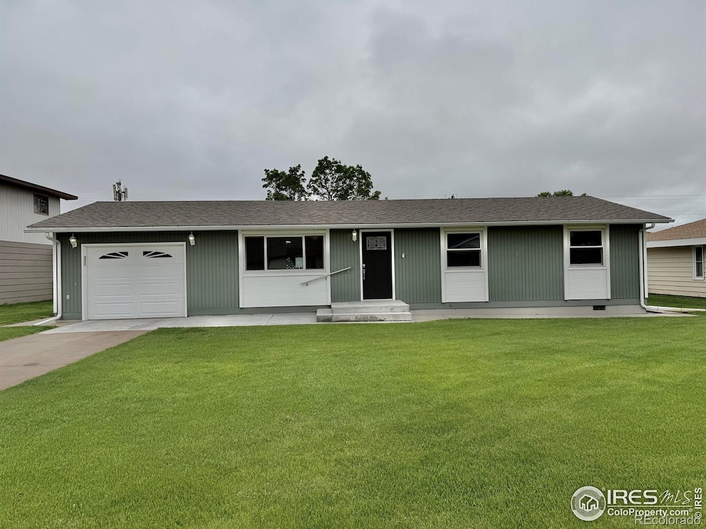 830 S Bowman Ave, Holyoke, CO 80734 - ranch-style house featuring a front lawn, driveway, and a garage