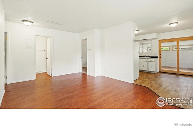 416 E Thunderbird Dr, Fort Collins, CO 80525 - unfurnished living room featuring wood finished floors and a sink
