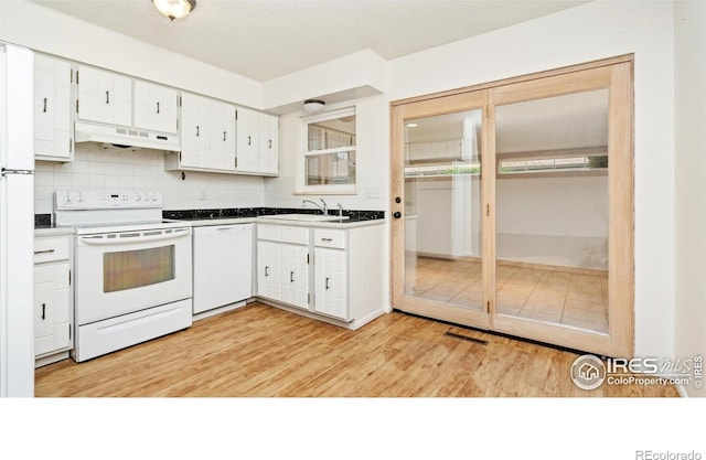 416 E Thunderbird Dr, Fort Collins, CO 80525 - kitchen with white appliances, under cabinet range hood, white cabinets, decorative backsplash, and light wood-type flooring