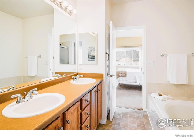 1122 Olympia Ave Unit 12H, Longmont, CO 80504 - ensuite bathroom featuring double vanity, a garden tub, and tile patterned flooring