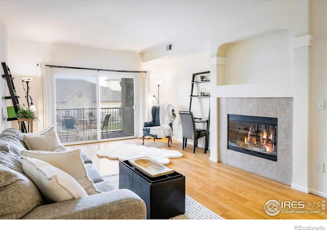 1122 Olympia Ave Unit 12H, Longmont, CO 80504 - living area with wood finished floors and a tiled fireplace
