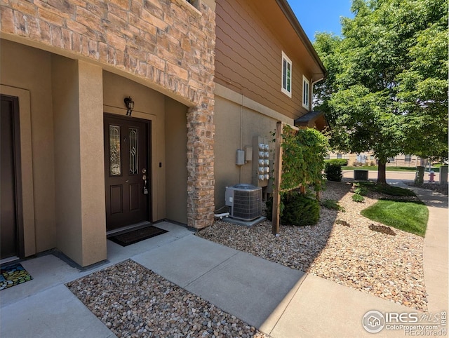 1122 Olympia Ave Unit 12H, Longmont, CO 80504 - view of exterior entry with stone siding and stucco siding