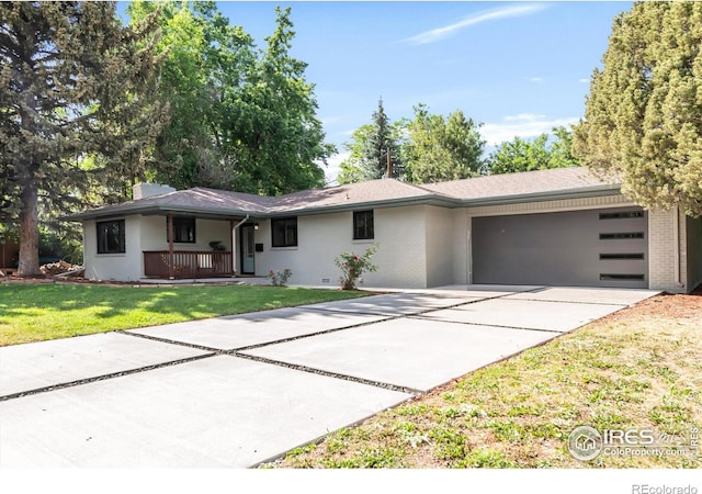 2025 Grape Ave, Boulder, CO 80304 - ranch-style house with concrete driveway, a garage, a front yard, covered porch, and brick siding