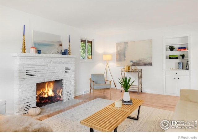 2025 Grape Ave, Boulder, CO 80304 - living area with a stone fireplace, wood finished floors, and built in features