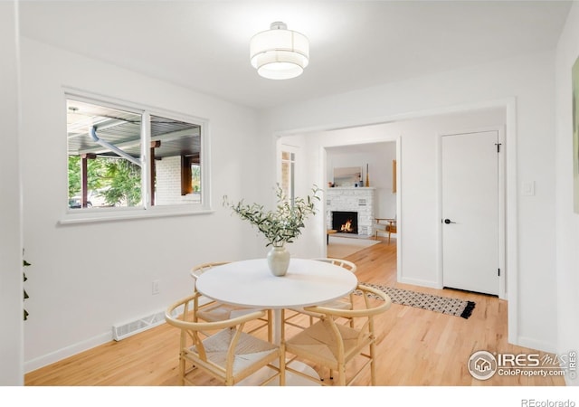 2025 Grape Ave, Boulder, CO 80304 - dining area with light wood-type flooring and a brick fireplace