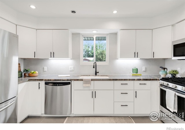 2025 Grape Ave, Boulder, CO 80304 - kitchen featuring appliances with stainless steel finishes, white cabinets, dark countertops, recessed lighting, and light tile patterned floors