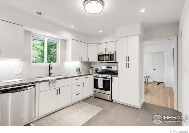 2025 Grape Ave, Boulder, CO 80304 - kitchen with appliances with stainless steel finishes, white cabinetry, light tile patterned floors, and recessed lighting